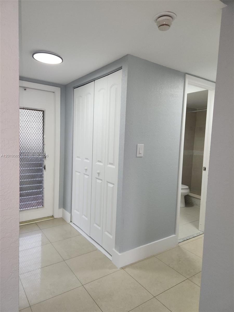 2811 North Pine Island Road, Unit 107 Sunrise, FL 33322 - Photo 7 of 16 an empty room with closet and bathroom