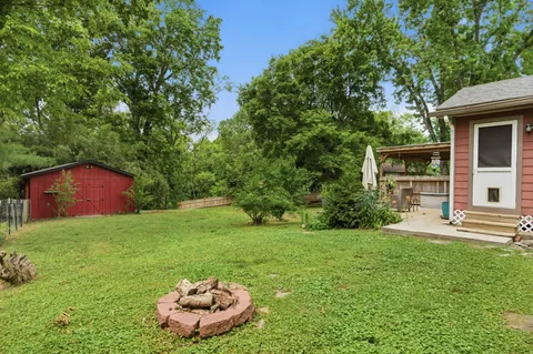 a view of a wooden house with a yard