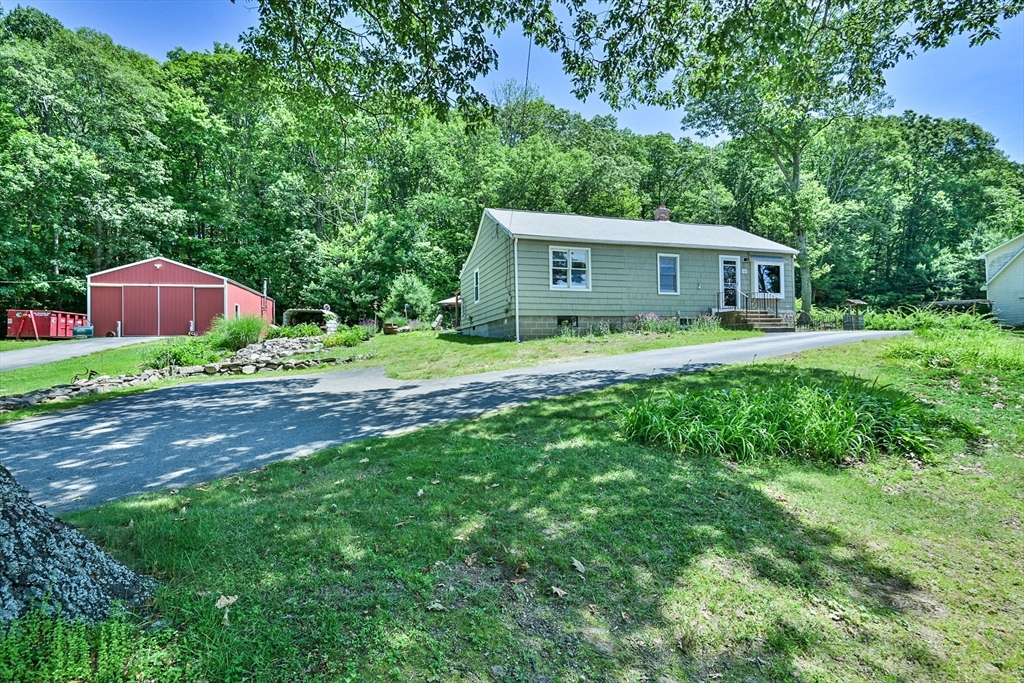161 Gore Road Webster, MA 01570 - Photo 2 of 42 a house that is sitting in middle od the grass