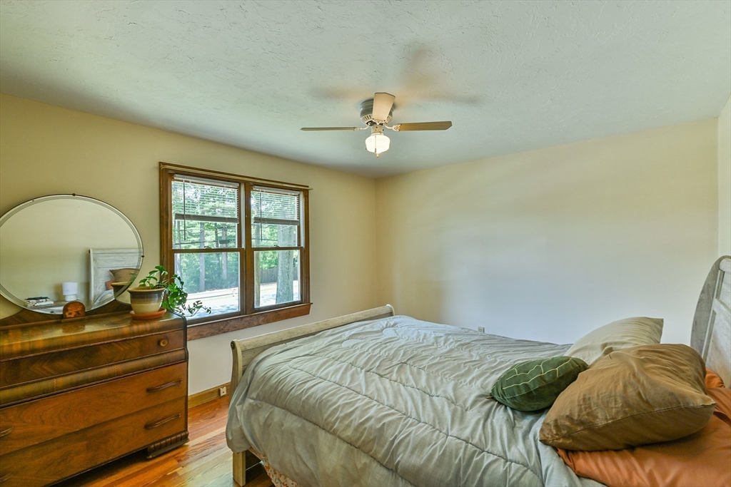 161 Gore Road Webster, MA 01570 - Photo 30 of 42 a bedroom with a bed and a chandelier