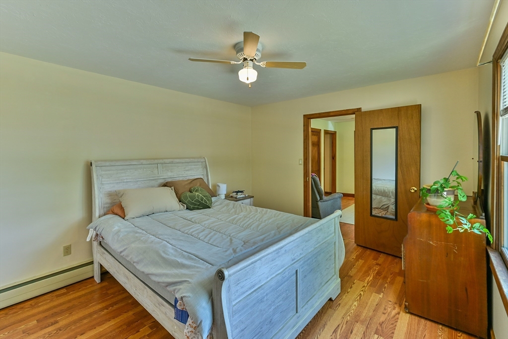 161 Gore Road Webster, MA 01570 - Photo 32 of 42 a bedroom with a bed and wooden floor