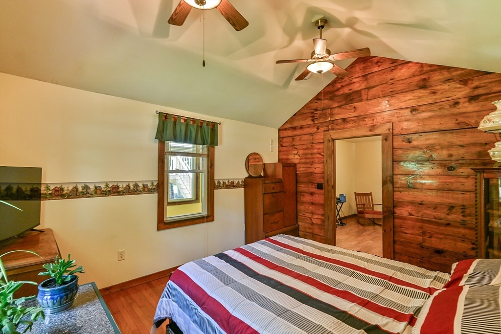 161 Gore Road Webster, MA 01570 - Photo 37 of 42 a bedroom with a bed and a chandelier