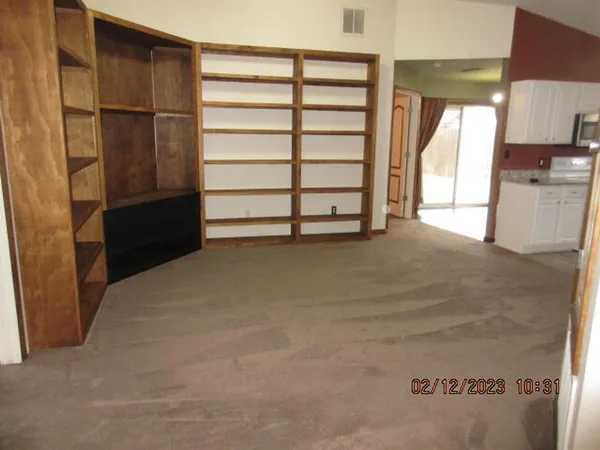a view of a closet area with an empty room