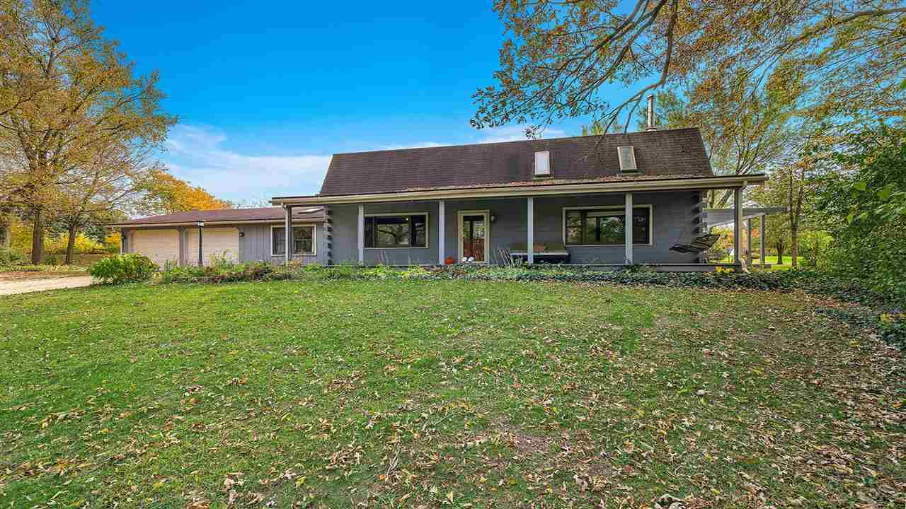6315 North River Road Byron, IL 61010 - Photo 1 of 40 a front view of a house with a garden