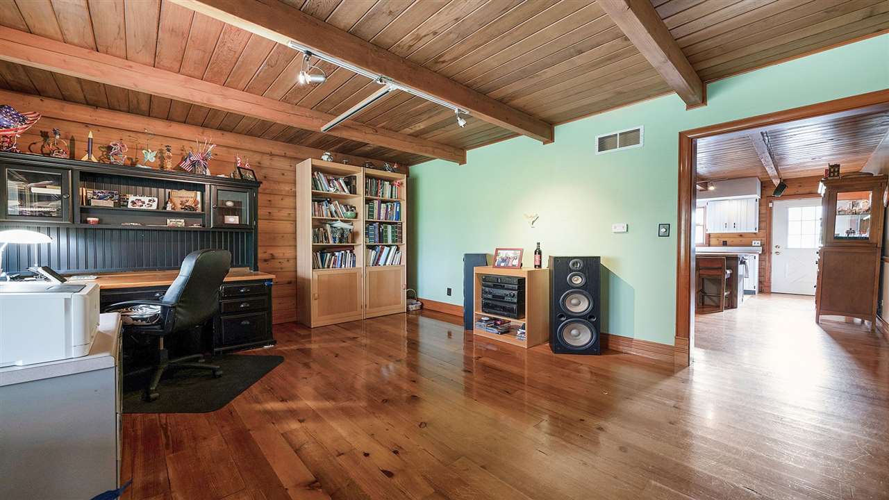 6315 North River Road Byron, IL 61010 - Photo 11 of 40 a living room with furniture and a flat screen tv
