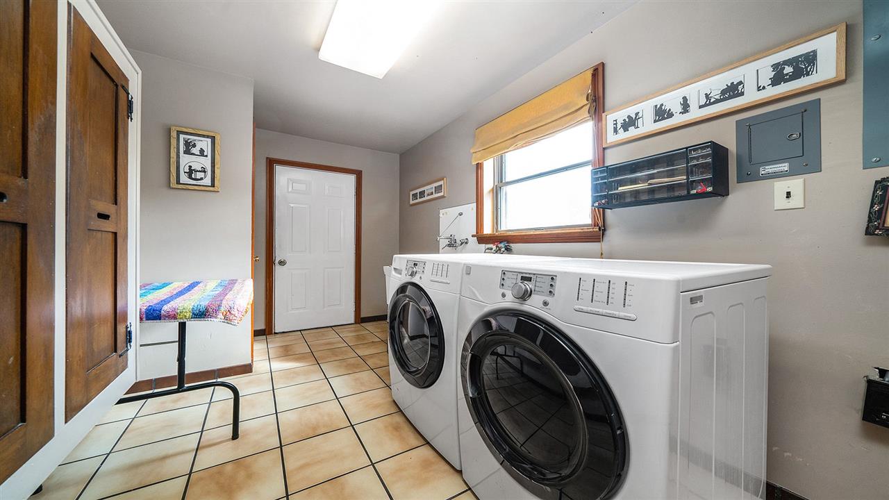 6315 North River Road Byron, IL 61010 - Photo 12 of 40 a view of a hallway with washer and dryer