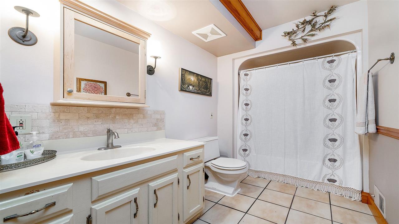 6315 North River Road Byron, IL 61010 - Photo 15 of 40 a bathroom with a sink a toilet and a large mirror
