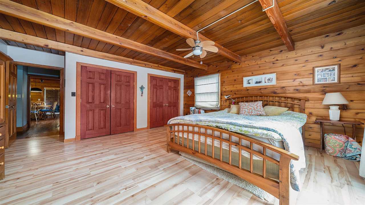 6315 North River Road Byron, IL 61010 - Photo 16 of 40 a spacious bedroom with a bed and wooden floor