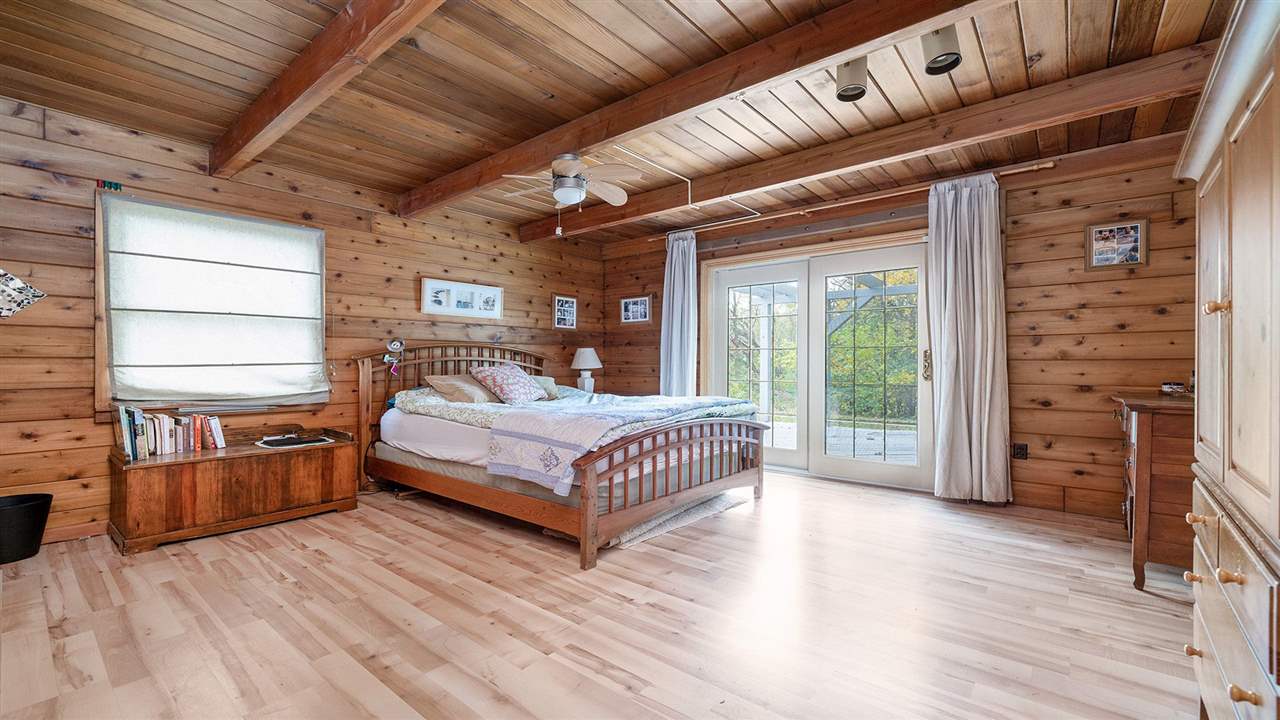 6315 North River Road Byron, IL 61010 - Photo 17 of 40 a spacious bedroom with a bed and wooden floor