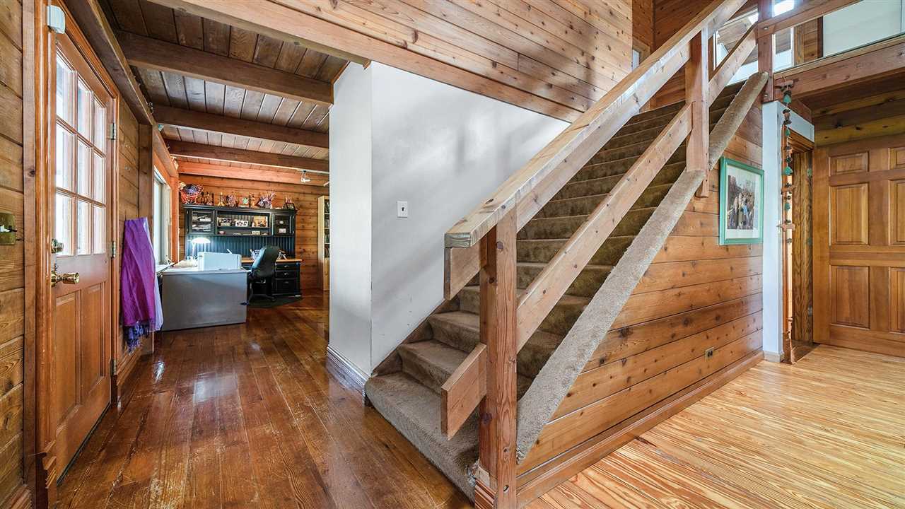 6315 North River Road Byron, IL 61010 - Photo 19 of 40 a view of a hallway with wooden floor and staircase
