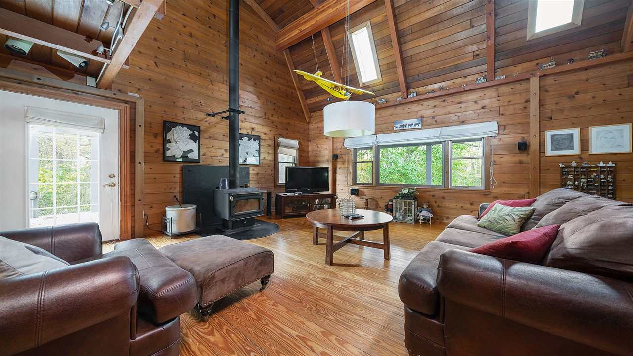 6315 North River Road Byron, IL 61010 - Photo 2 of 40 a living room with furniture a fireplace and a large window