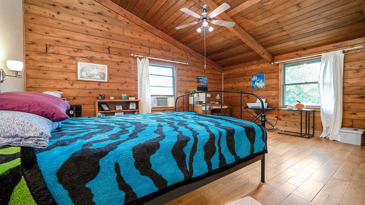 6315 North River Road Byron, IL 61010 - Photo 21 of 40 a bed sitting in a bedroom next to a window