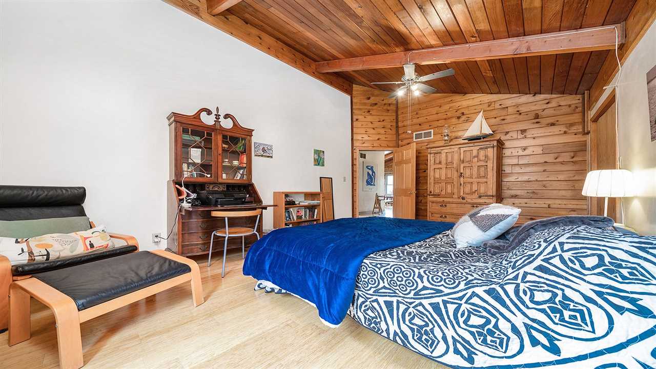 6315 North River Road Byron, IL 61010 - Photo 22 of 40 a bedroom with a bed and a lamp with the dresser