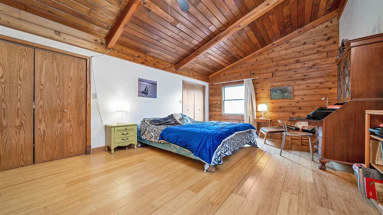 6315 North River Road Byron, IL 61010 - Photo 23 of 40 a bedroom with a bed and wooden floor