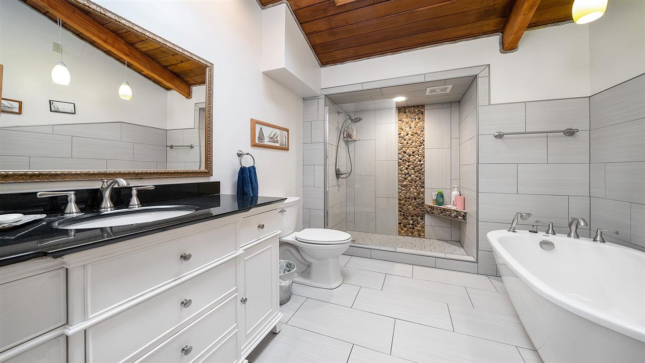 6315 North River Road Byron, IL 61010 - Photo 24 of 40 a bathroom with a toilet a sink a mirror and a bathtub