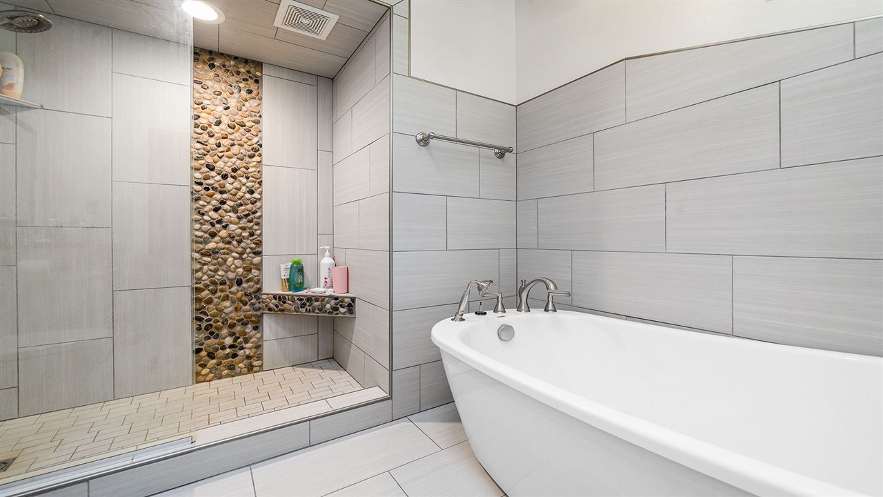 6315 North River Road Byron, IL 61010 - Photo 25 of 40 a bathroom with bathtub and shower