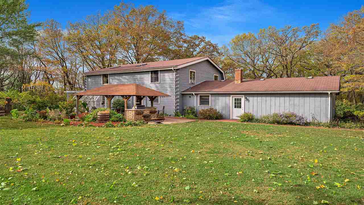 6315 North River Road Byron, IL 61010 - Photo 34 of 40 a front view of a house with yard and porch