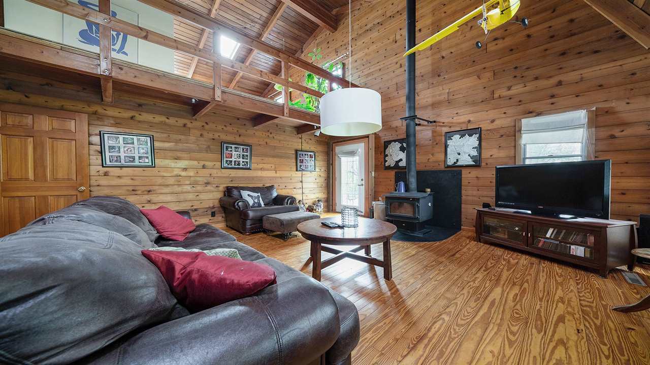 6315 North River Road Byron, IL 61010 - Photo 4 of 40 a living room with furniture and a flat screen tv