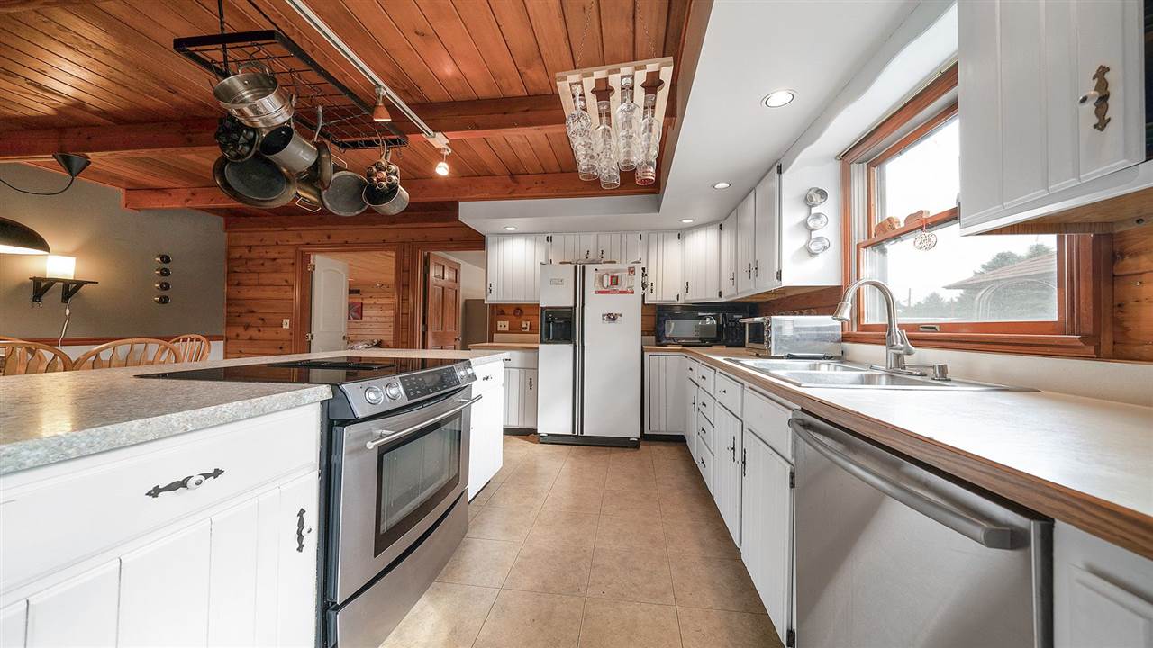 6315 North River Road Byron, IL 61010 - Photo 5 of 40 a kitchen with stainless steel appliances granite countertop a sink a stove and cabinets