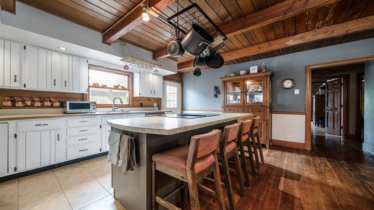 6315 North River Road Byron, IL 61010 - Photo 6 of 40 a kitchen with stainless steel appliances granite countertop a table chairs and a refrigerator