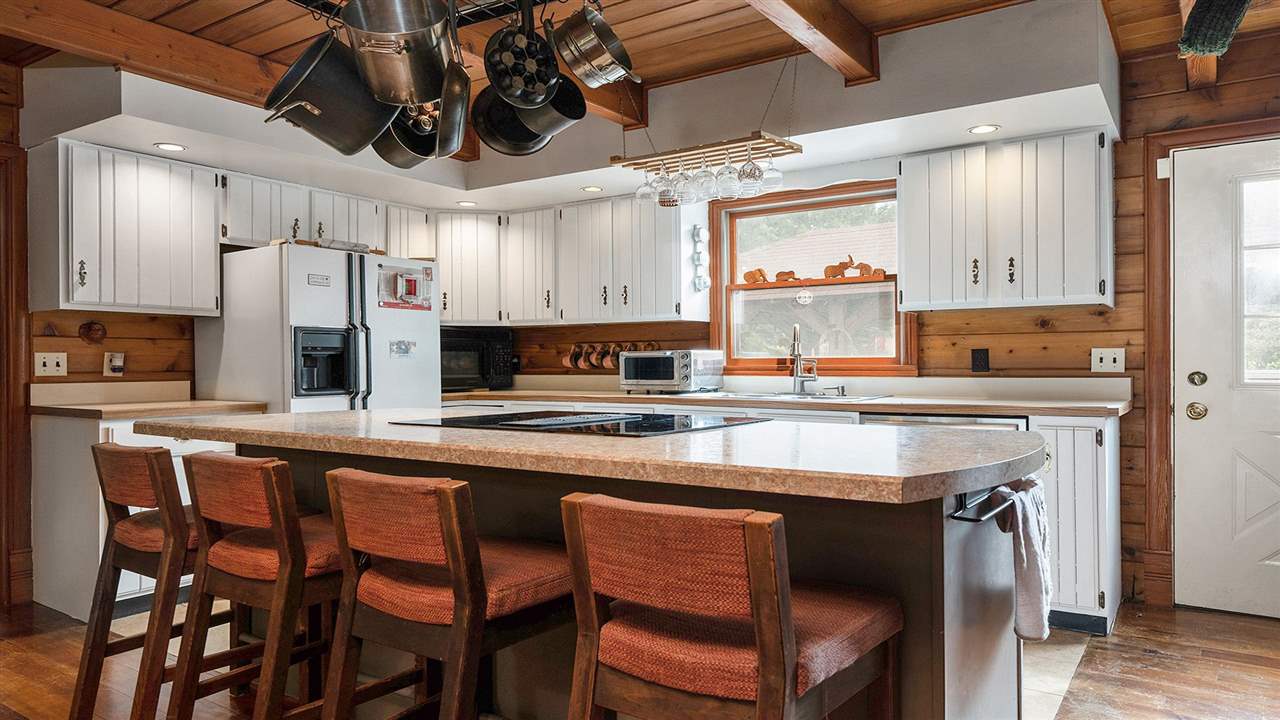 6315 North River Road Byron, IL 61010 - Photo 7 of 40 a kitchen with stainless steel appliances granite countertop a table chairs sink and cabinets