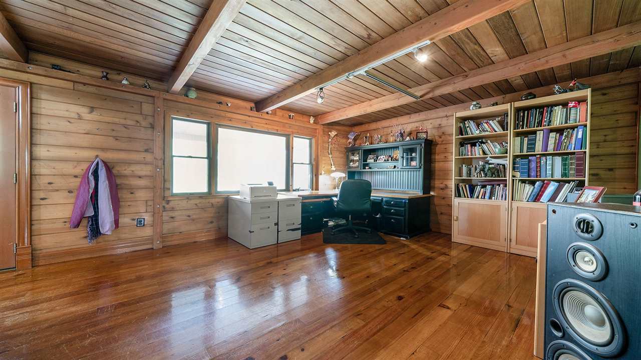 6315 North River Road Byron, IL 61010 - Photo 10 of 40 a living room with furniture and a book shelf