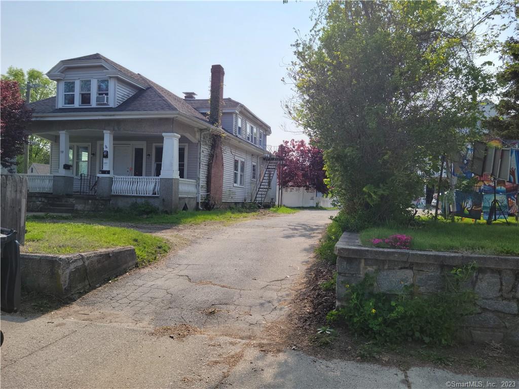 59 Broad Street Killingly, CT 06239 - Photo 1 of 1 a front view of a house with a yard table and chairs