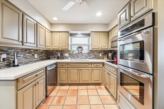 a dining room with furniture a wooden floor and next to a large window