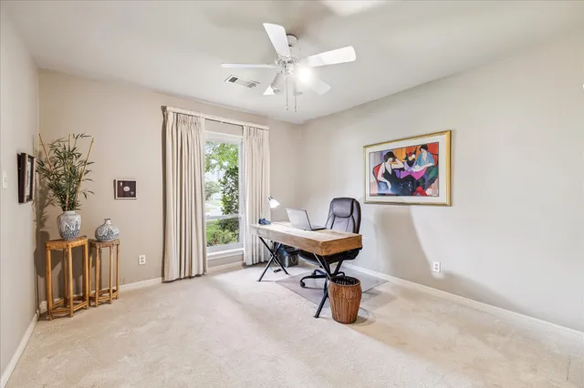 a view of a patio with table and chairs potted plants and floor to ceiling window