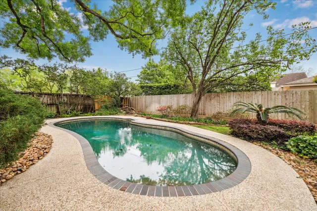 a view of a house with pool and a chairs