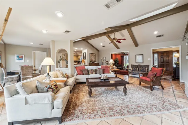 a living room with fireplace furniture and a table