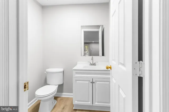 a white toilet sitting next to a bathroom sink