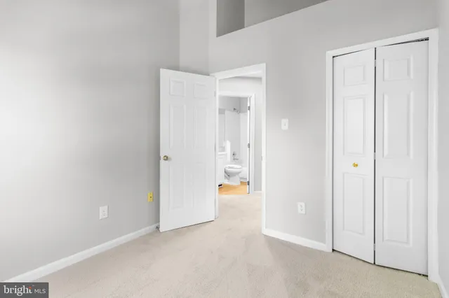 a view of an empty room and bathroom