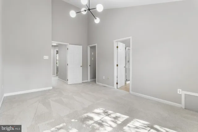 an empty room with fan and entrance