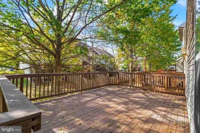 a balcony with wooden floor and fence