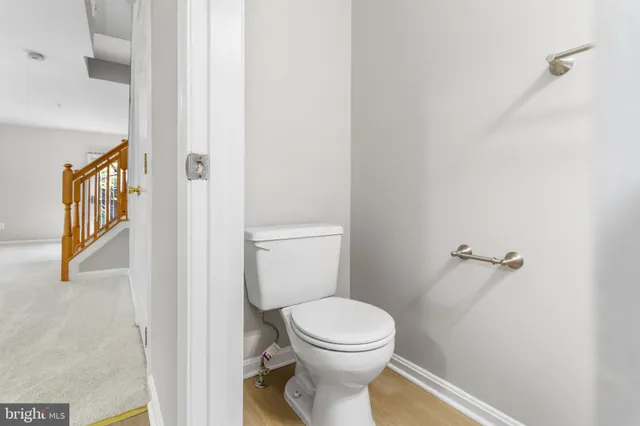 a white toilet sitting next to a bathroom sink