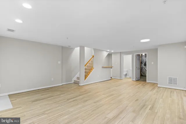 a view of an empty room with wooden floor