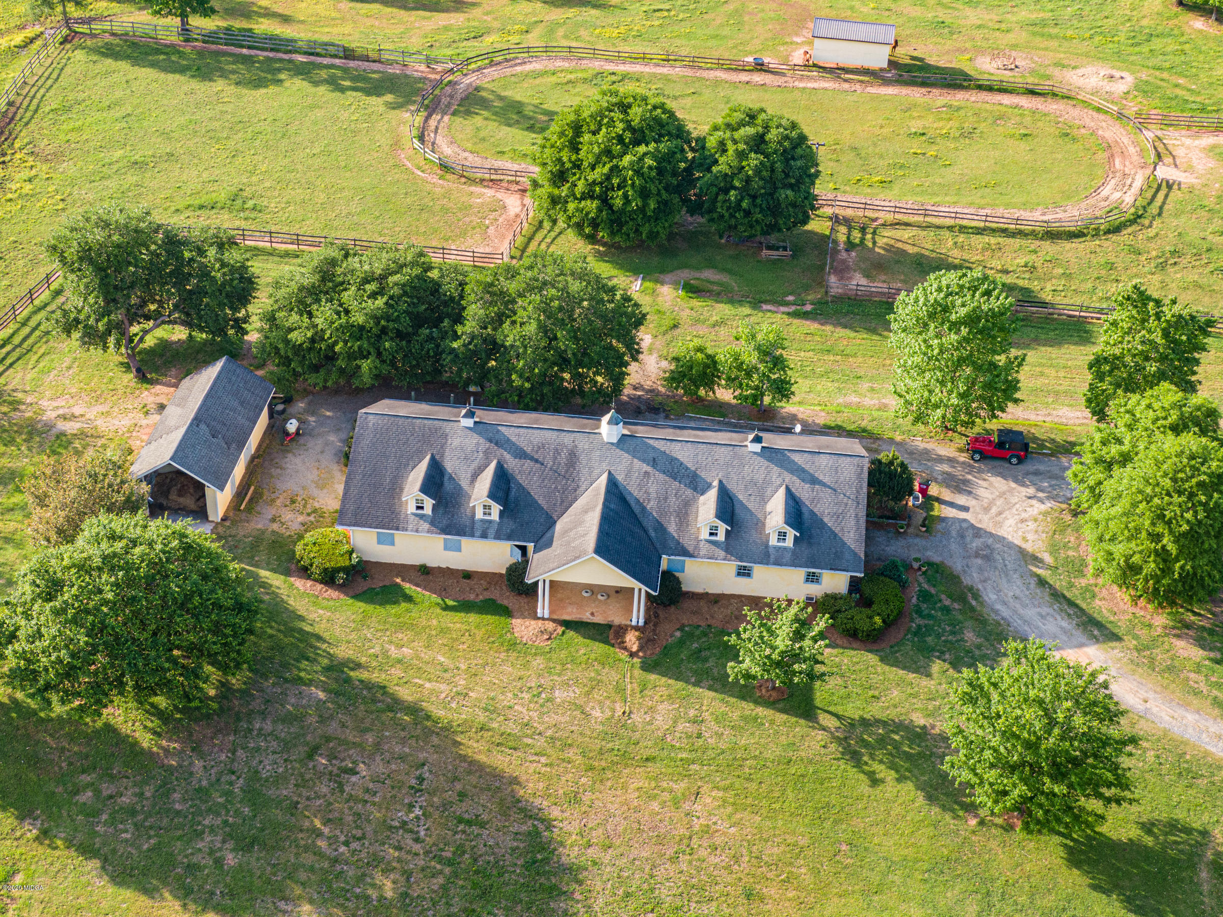 265 Sanders Road Macon, GA 31210 - Photo 42 of 61 an aerial view of a house with a garden and lake view