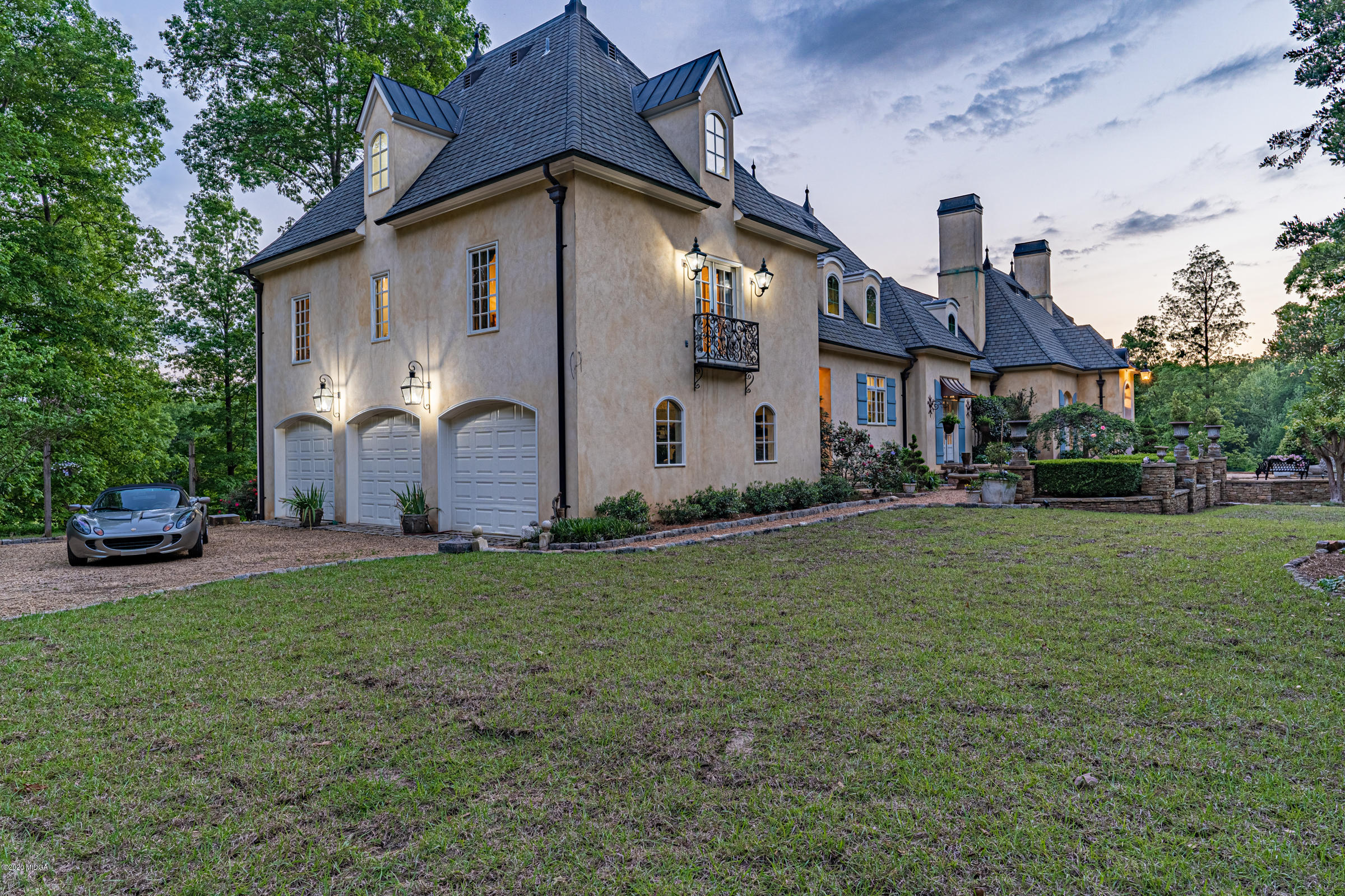 265 Sanders Road Macon, GA 31210 - Photo 49 of 61 a front view of a house with a garden and plants