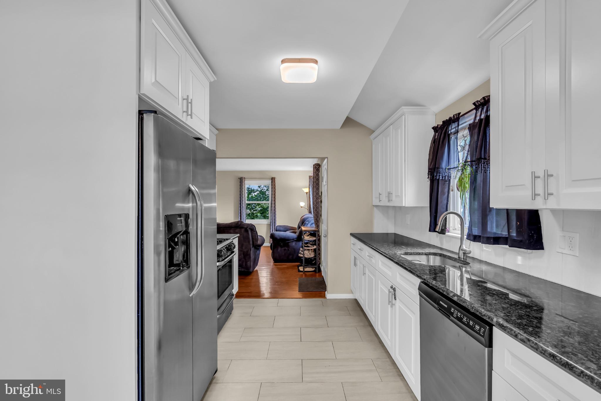 2002 South Brighton Avenue Clementon, NJ 08021 - Photo 14 of 38 a kitchen with stainless steel appliances granite countertop lots of counter top space and wooden floor