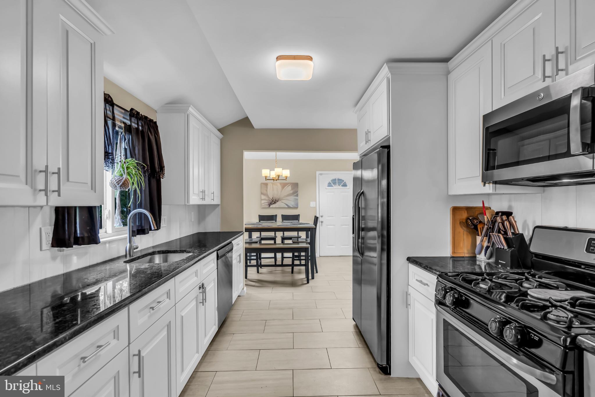 2002 South Brighton Avenue Clementon, NJ 08021 - Photo 17 of 38 a kitchen with stainless steel appliances kitchen island granite countertop a stove and a sink
