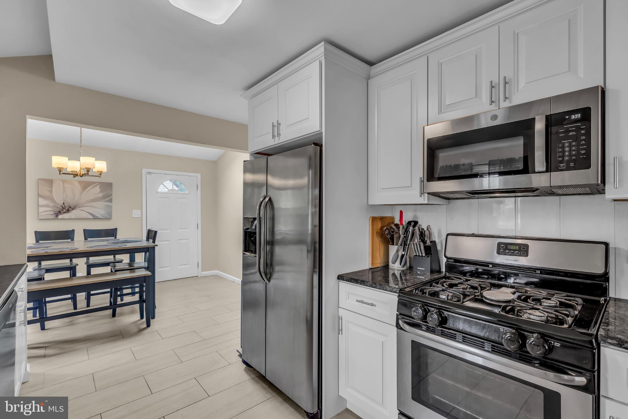 2002 South Brighton Avenue Clementon, NJ 08021 - Photo 18 of 38 a kitchen with stainless steel appliances a stove a microwave and cabinets