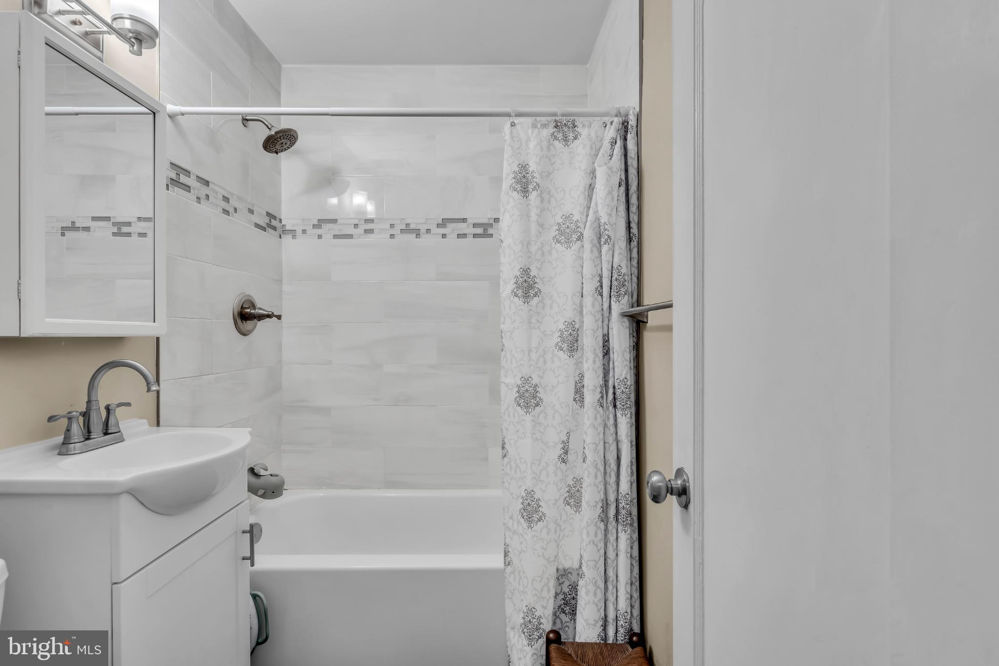 2002 South Brighton Avenue Clementon, NJ 08021 - Photo 24 of 38 a bathroom with a shower a mirror and a sink