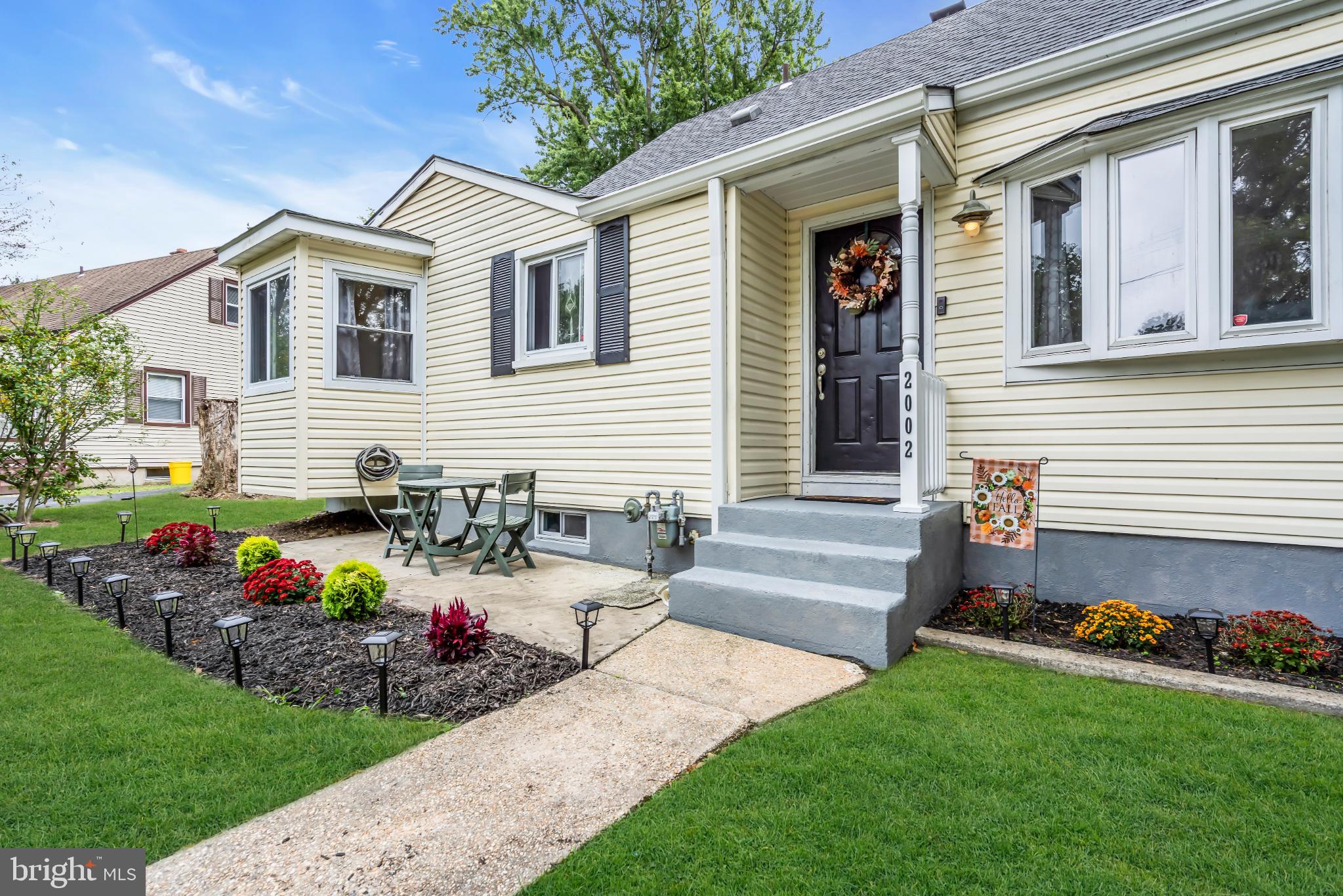 2002 South Brighton Avenue Clementon, NJ 08021 - Photo 7 of 38 a front view of a house with a yard and chairs