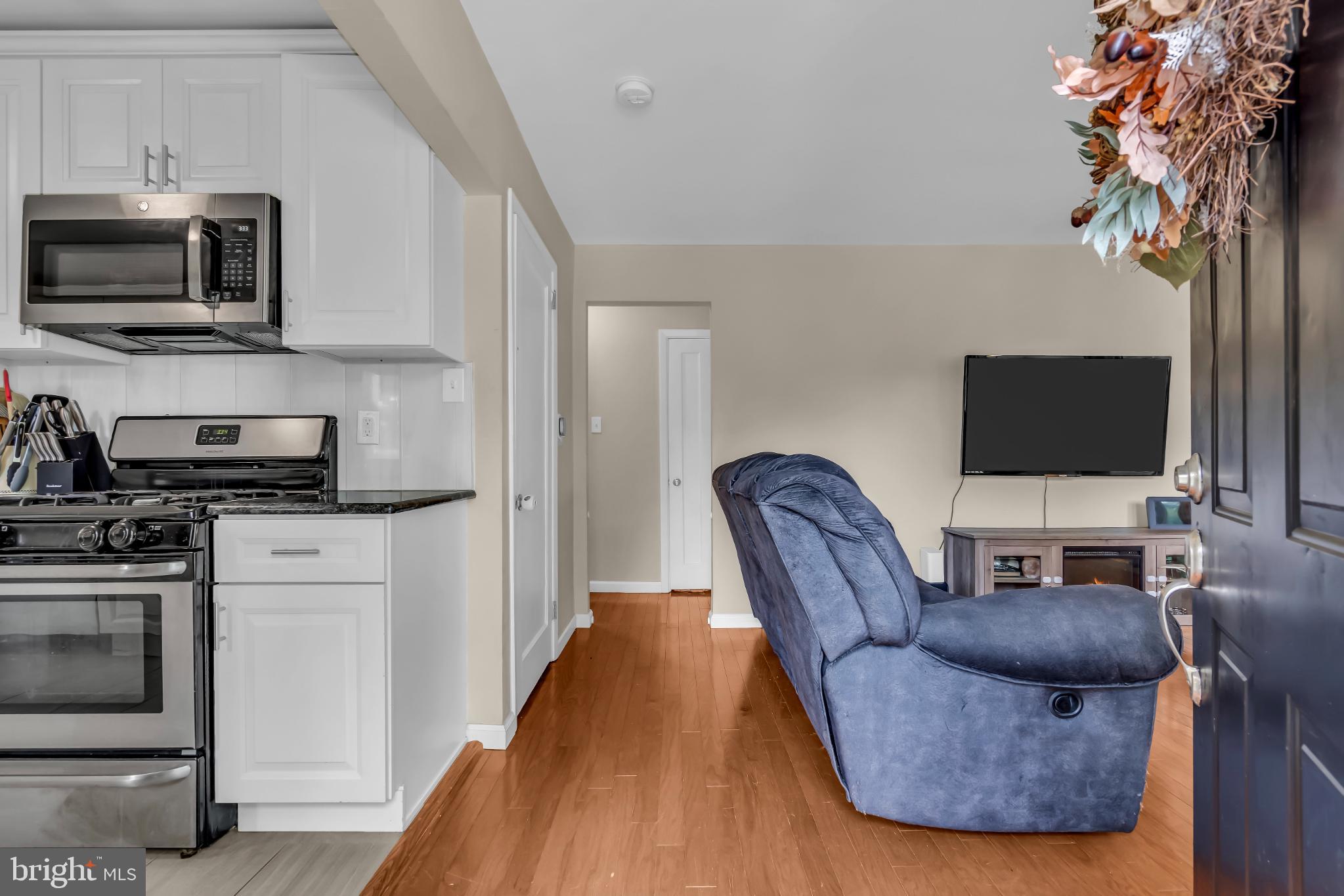 2002 South Brighton Avenue Clementon, NJ 08021 - Photo 9 of 38 a living room with furniture a flat screen tv and kitchen view