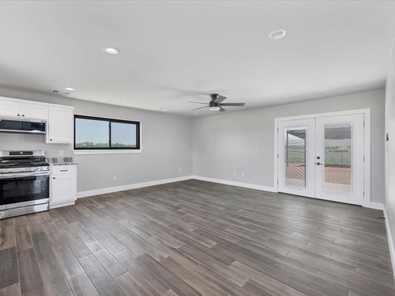 2719 Post Oak Road Webberville, TX 78653 - Photo 10 of 23 a view of a kitchen with wooden floor and electronic appliances
