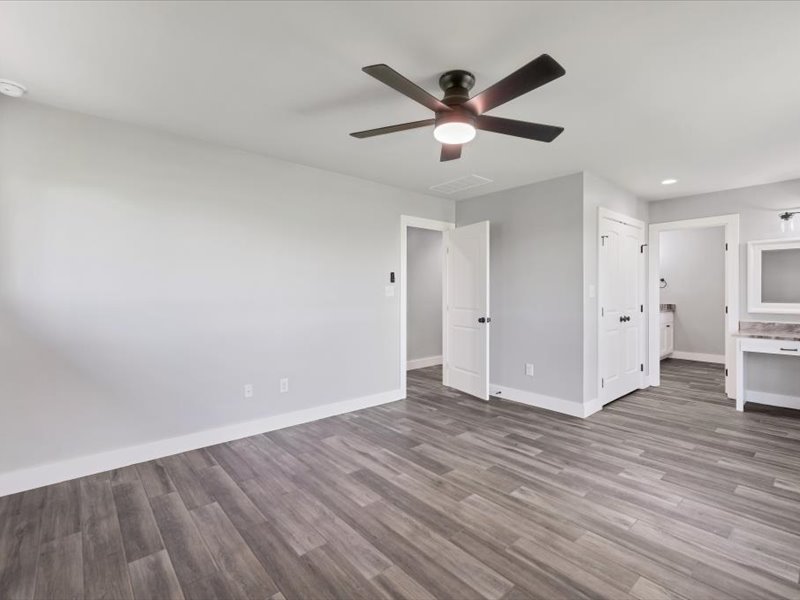 2719 Post Oak Road Webberville, TX 78653 - Photo 11 of 23 a view of a livingroom with wooden floor and a ceiling fan