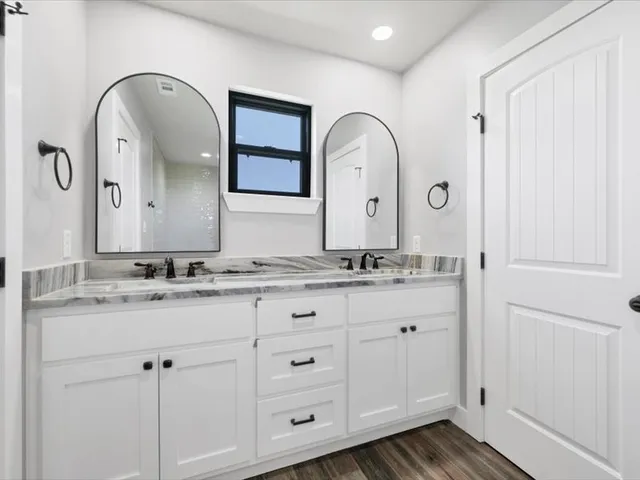 a view of a livingroom with wooden floor and a ceiling fan