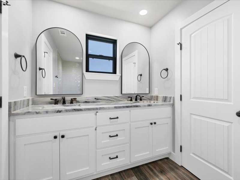 2719 Post Oak Road Webberville, TX 78653 - Photo 13 of 23 a bathroom with double vanity sinks and a mirror