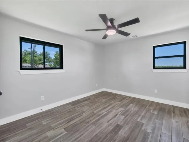 a bathroom with double vanity sinks and a mirror